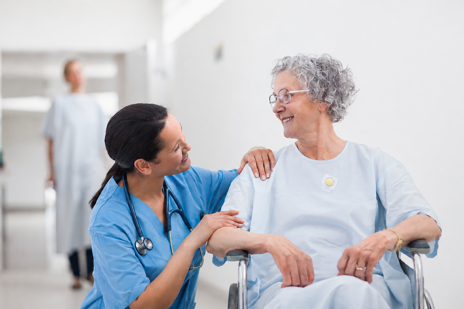Image of a nurse comforting a woman in a wheelchair